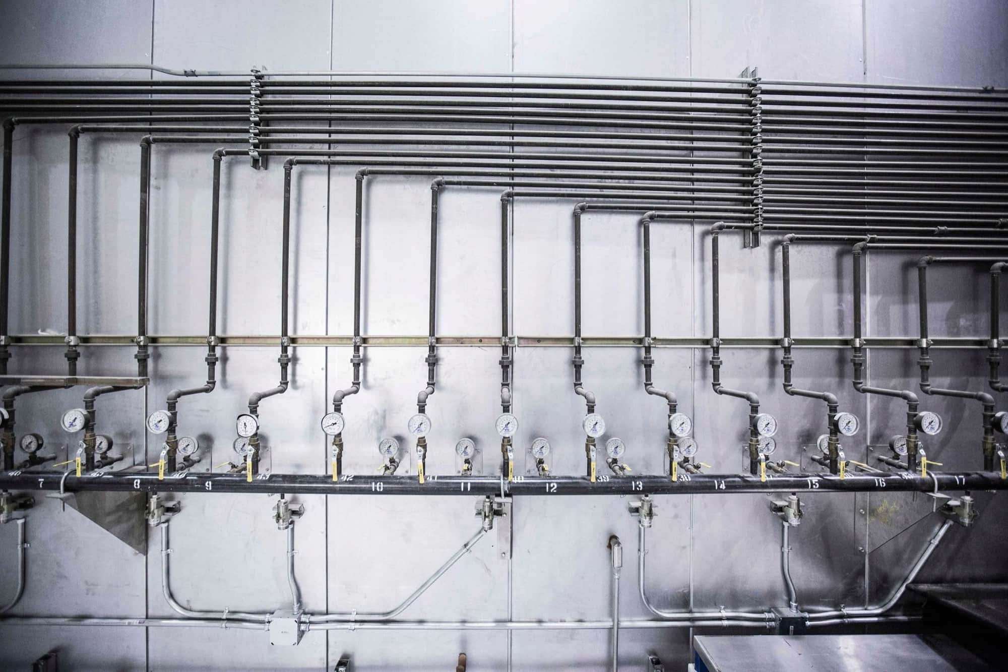 Hydraulic pipework and pressure gauges on an industrial manifold