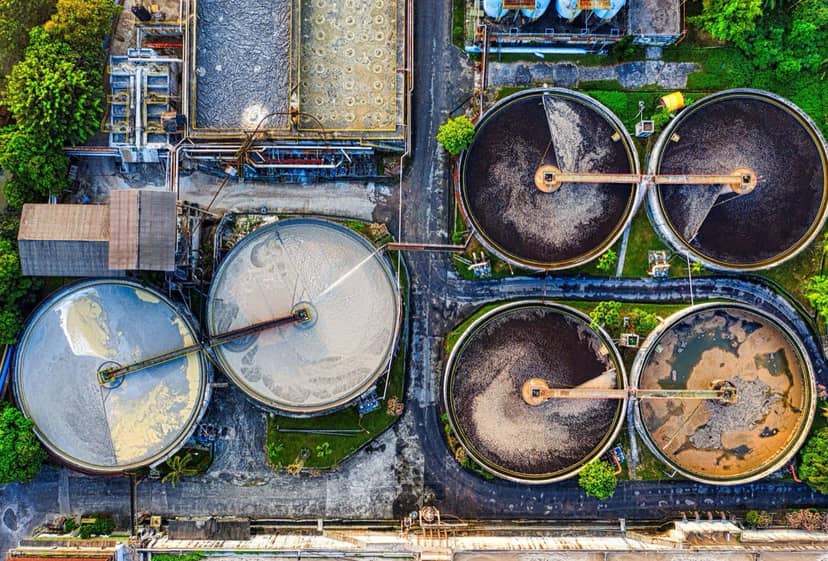 Aerial view of circular wastewater treatment settling tanks