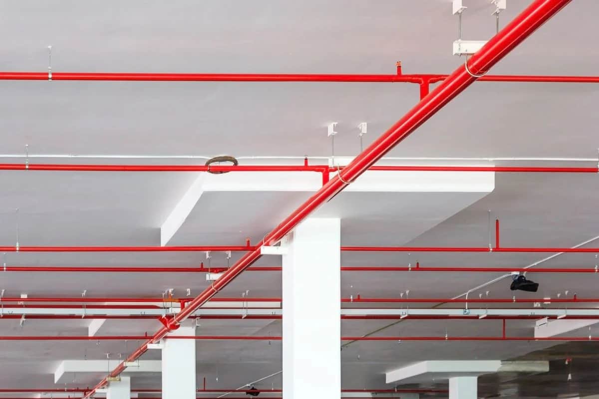Red fire sprinkler pipework installed across a ceiling